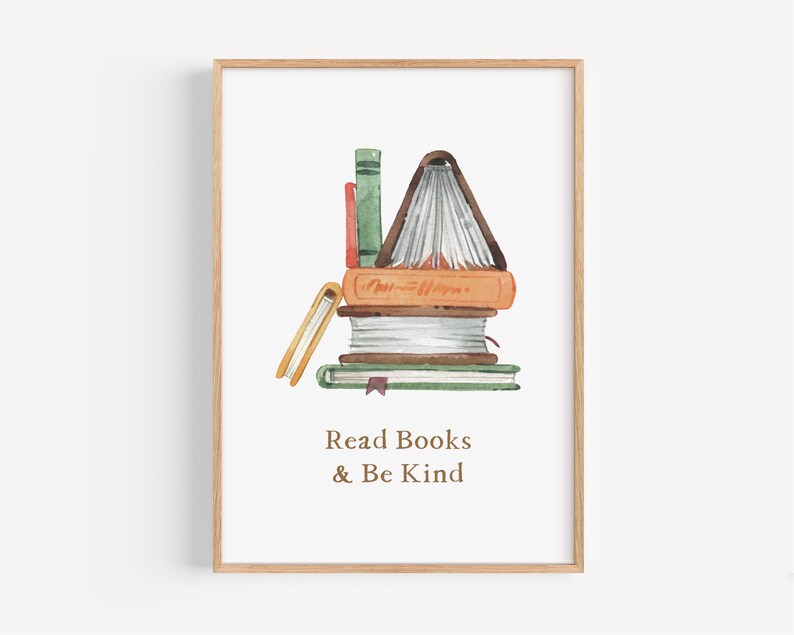 The image is a framed print with a watercolor illustration of a stack of books. The text below the illustration reads "Read Books & Be Kind".