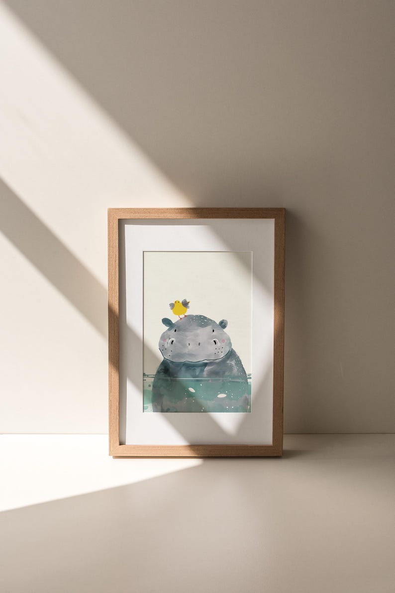 A framed illustration of a hippopotamus with a yellow flower on its head is displayed on a white wall.