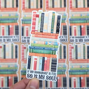 May include: A white sticker with a stack of colorful books and the text "If my bookshelf is full so is my soul".