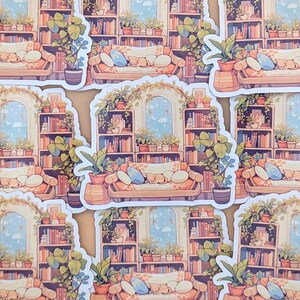 May include: A set of stickers featuring a cozy living room scene with a bookshelf filled with books, plants, and a couch with pillows. The stickers are illustrated in a cartoon style with soft colors.