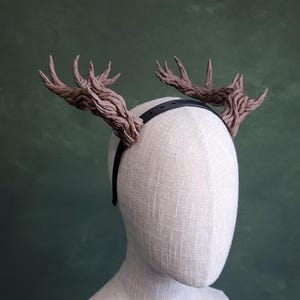 May include: A set of three ceramic mugs with a speckled, matte finish. The mugs are in shades of cream, light gray, and dark gray. Each mug has a simple, minimalist design, perfect for coffee or tea.