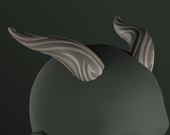May include: A gray sculpted head with two stylized horns. The horns are detailed with a swirling pattern.