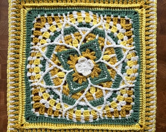 May include: A square, handmade crochet piece featuring a floral design. The piece uses yellow, white, and green yarn. The central flower is white, surrounded by green and yellow petals. The border is yellow with a decorative edge.