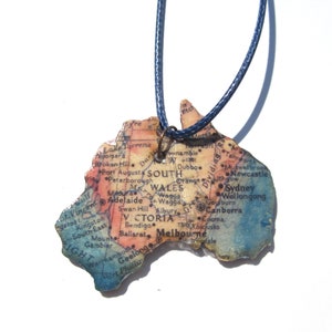 Lasercutted wooden world map necklace. image 1