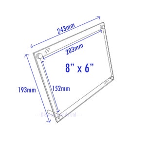 May include: A clear acrylic picture frame with dimensions of 8 inches by 6 inches, 243 mm by 203 mm, and 193 mm by 152 mm.