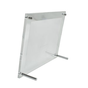 May include: A clear acrylic picture frame with a silver stand. The frame is designed to stand upright on a table or shelf.