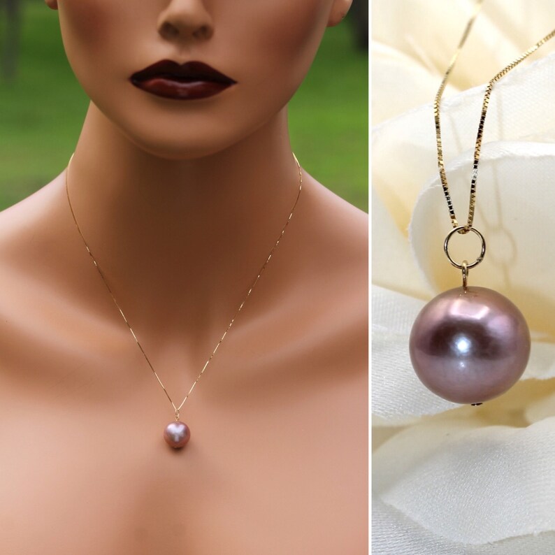 May include: A gold chain necklace with a large, round, mauve pearl pendant.