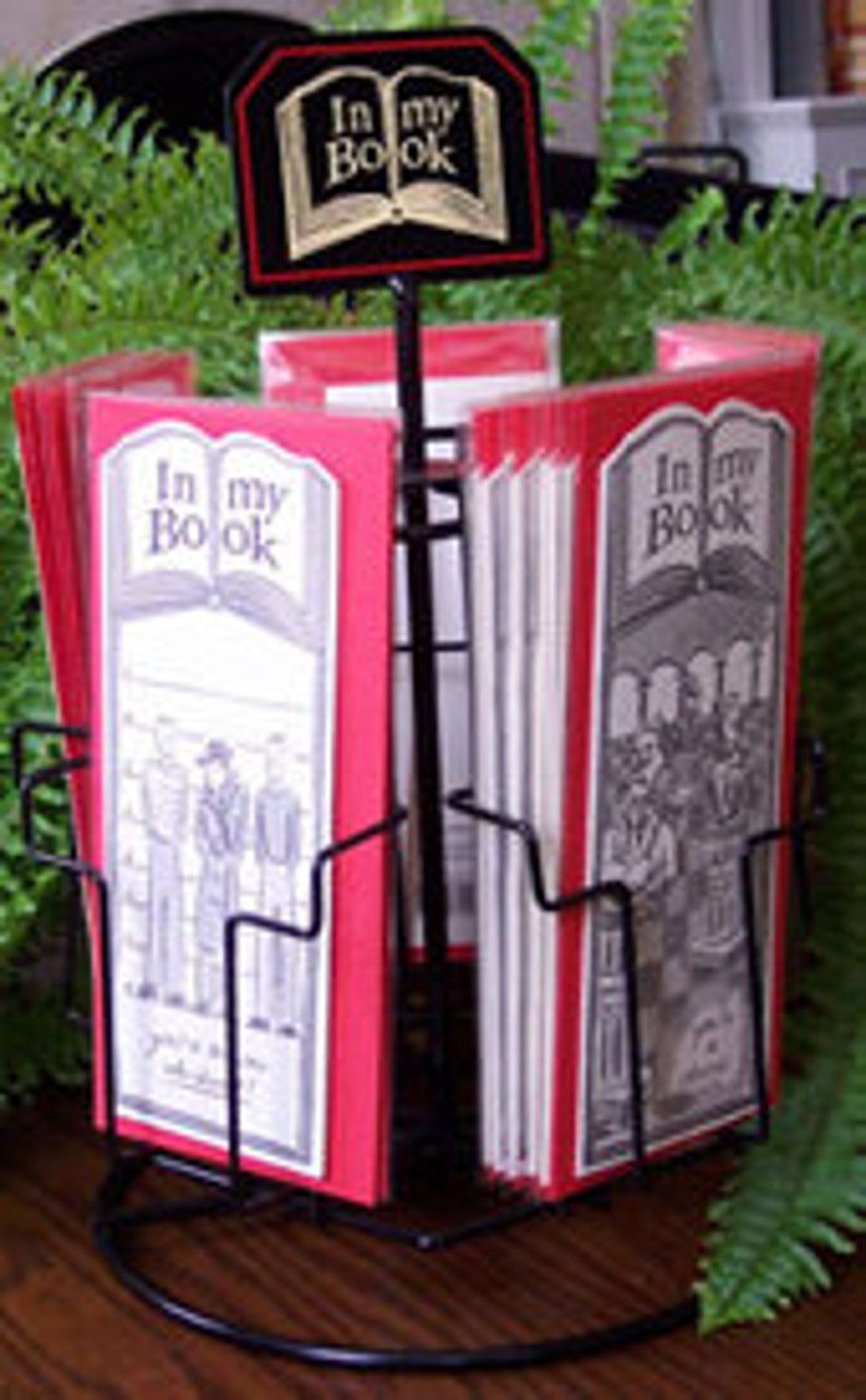 May include: A black metal display stand with red and white bookmarks featuring the text "In my Book" and illustrations of people.