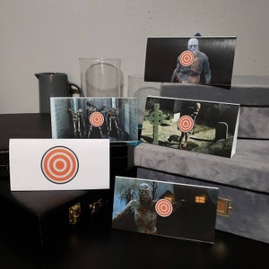 May include: Five printable target cards featuring zombies with red bullseye targets. The cards are printed on white cardstock and are ready to be cut out and used for a zombie-themed game.