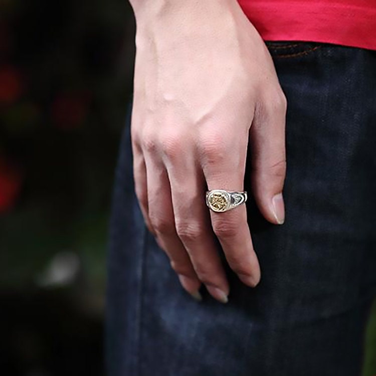 polished silver ring on index finger