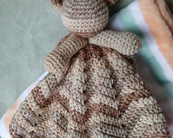 Teddy bear lovey on a round ripple blanket