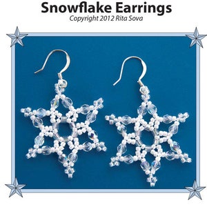 May include: A pair of snowflake earrings made with white beads and silver hooks. The earrings are on a blue background.