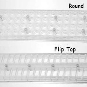 May include: Two clear plastic trays for storing small items. The top tray has round compartments labeled "Round". The bottom tray has rectangular compartments labeled "Flip Top".