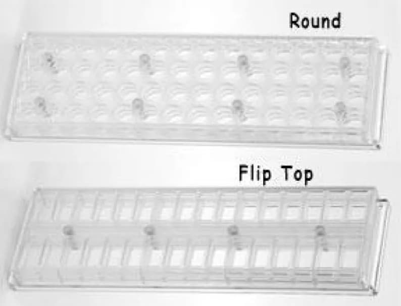 May include: Two clear plastic trays for storing small items. The top tray has round compartments labeled "Round". The bottom tray has rectangular compartments labeled "Flip Top".