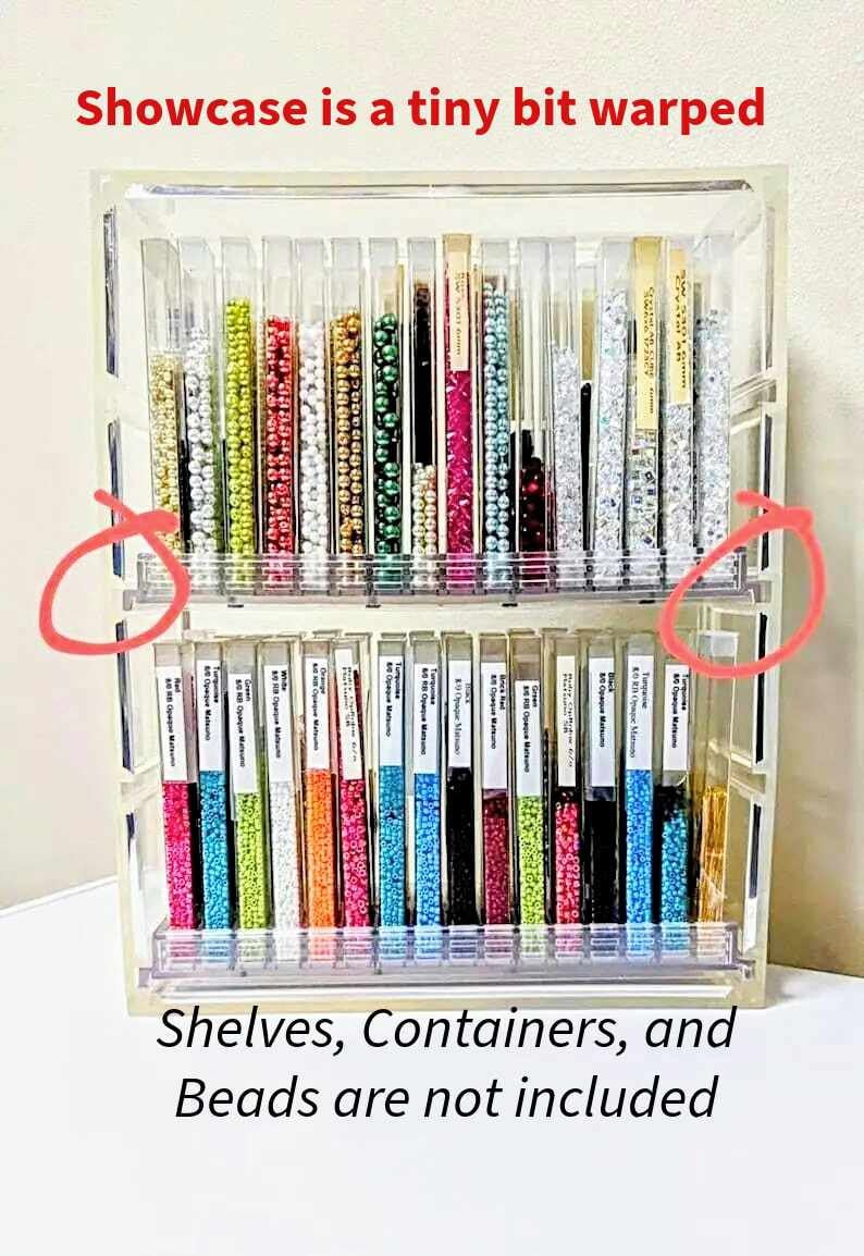 May include: A clear acrylic bead storage organizer with two shelves. The organizer has multiple compartments for storing beads. The shelves are labeled with the text "80 Opaque Matte".