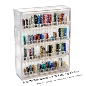 May include: A clear plastic bead storage organizer with four flip-top shelves. Each shelf has multiple small compartments for storing beads. The text on the bottom reads "Bead Pavilion Showcase with 4 Flip Top Shelves. Beads NOT included - See options; with or without containers."