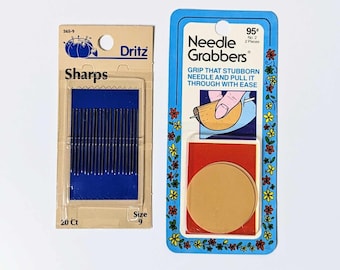 May include: Two packages of sewing supplies. The first package contains 20 size 9 sewing needles. The second package contains two needle grabbers, which are tools for pulling needles through fabric. The package says "Grip that stubborn needle and pull it through with ease."