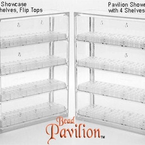 May include: Two clear plastic bead storage organizers with four shelves each. The organizer on the left has flip tops, while the organizer on the right has round tops. Both organizers are labeled "Pavilion Showcase with 4 Shelves".