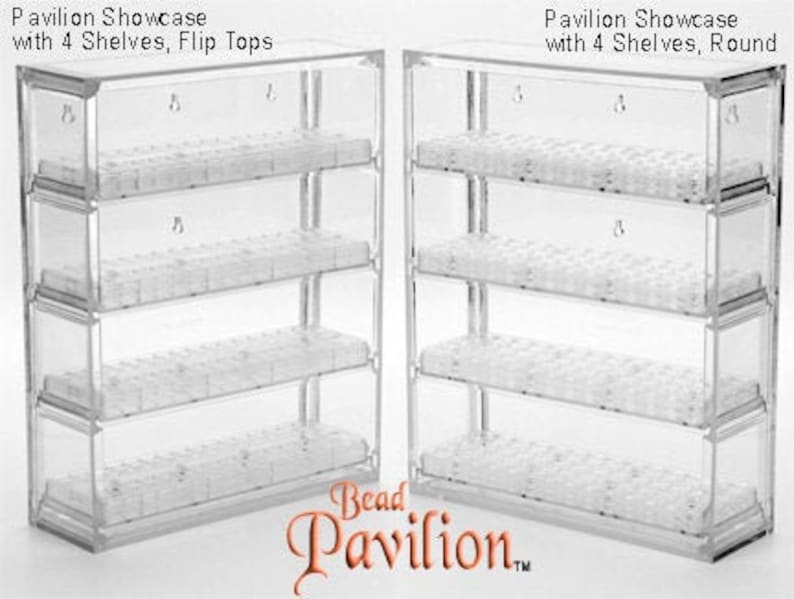 May include: Two clear plastic bead storage organizers with four shelves each. The organizer on the left has flip tops, while the organizer on the right has round tops. Both organizers are labeled "Pavilion Showcase with 4 Shelves".