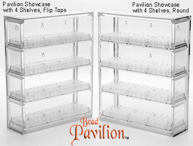 May include: Two clear plastic bead storage organizers with four shelves each. The organizer on the left has flip tops, while the organizer on the right has round tops. Both organizers are labeled "Pavilion Showcase with 4 Shelves".
