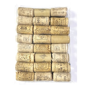 May include: A close-up of a bag of assorted wine corks. The corks are made of natural cork and have various labels and markings, including the words "Trento", "Cavit", "Concha y Toro", and "Bella Sera".