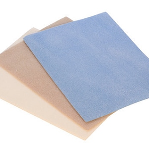 May include: Three fabric squares in different colors: white, beige, and light blue. The squares are stacked on top of each other, with the blue square on top.