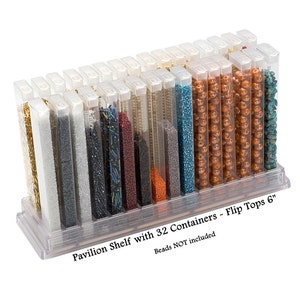 May include: A clear plastic storage rack featuring 32 vertical containers with flip-top lids, each 6 inches tall. The containers are filled with various colorful beads. The text on the base reads: Pavilion Shelf with 32 Containers - Flip Tops 6".