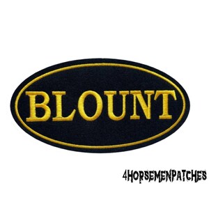 May include: Black oval patch with a gold embroidered outline and the word "BLOUNT" in gold lettering.