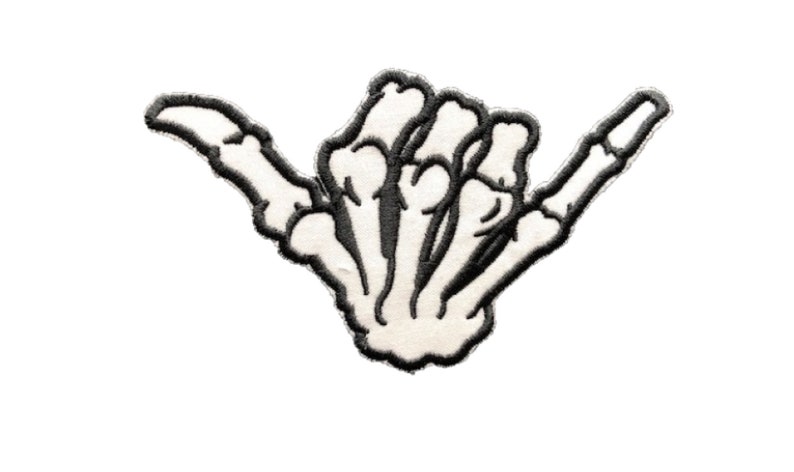 May include: Embroidered patch featuring a white skeleton hand in the shaka gesture, outlined in black. The patch has a cream-colored background and is designed to be ironed on or sewn onto fabric. Ideal for adding a unique touch to clothing or accessories.
