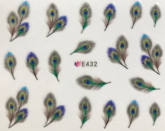 May include: A sheet of nail art stickers featuring peacock feather designs. The feathers are in shades of blue, green, brown, and gray, with a central eye pattern. The sheet also includes the text "E432".