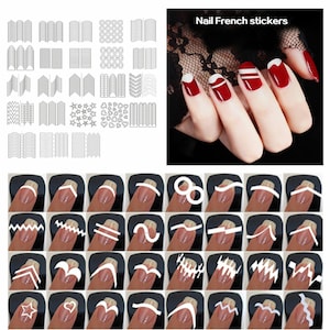 May include: Nail art stickers with various designs, including curved lines, zigzags, stars, hearts, and circles. The stickers are shown on a black background and on a hand with red and white nail polish.