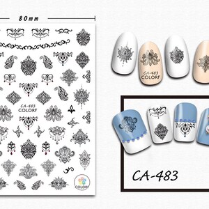 May include: Black and white nail art stickers with intricate designs, including paisley, floral, and geometric patterns. The sheet measures 80 mm by 103 mm and includes the product code CA-483.