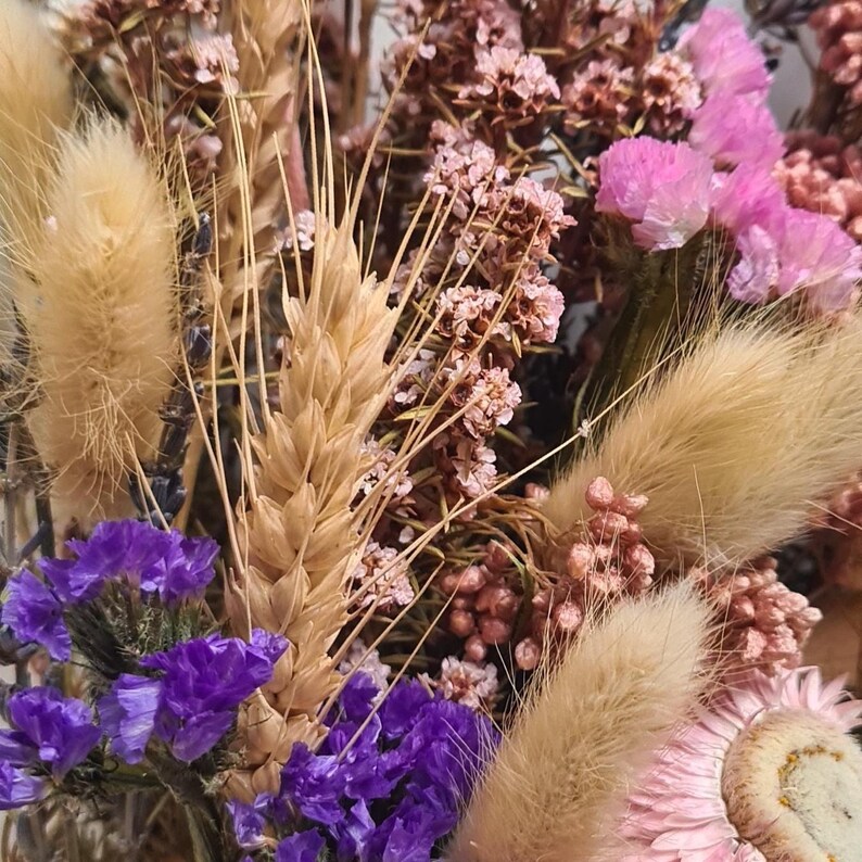 Close up of Dried flower bridal bouquet in soft pink, lilac and neutral tones