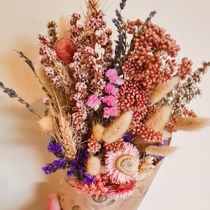 Dried flower bridal bouquet in soft pink, lilac and neutral tones tied with raffia