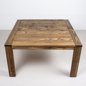 square outdoor dining table made with accoya wood on parson style base