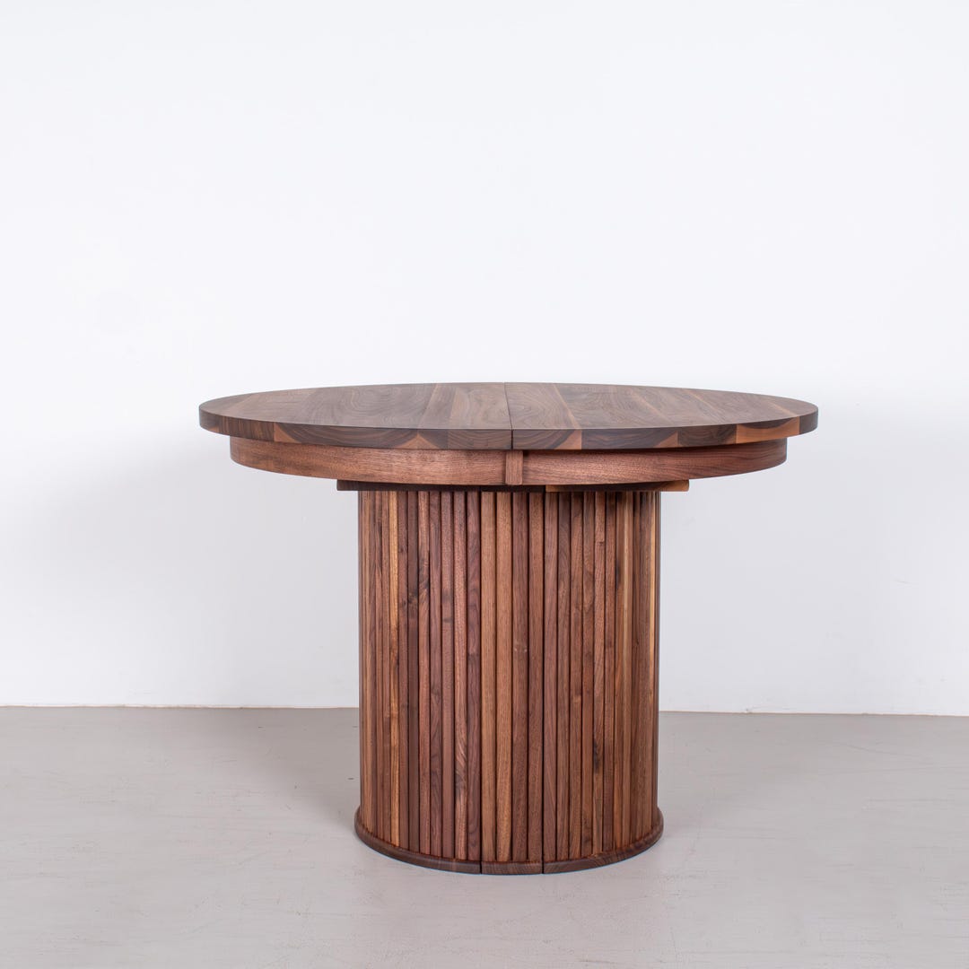 Round Extendable Walnut Modern Round Extendable Walnut Table on 3 Piece Fluted Pedestal Base ...