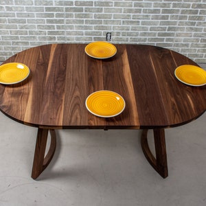 solid walnut oval table with leaves on wood curved legs