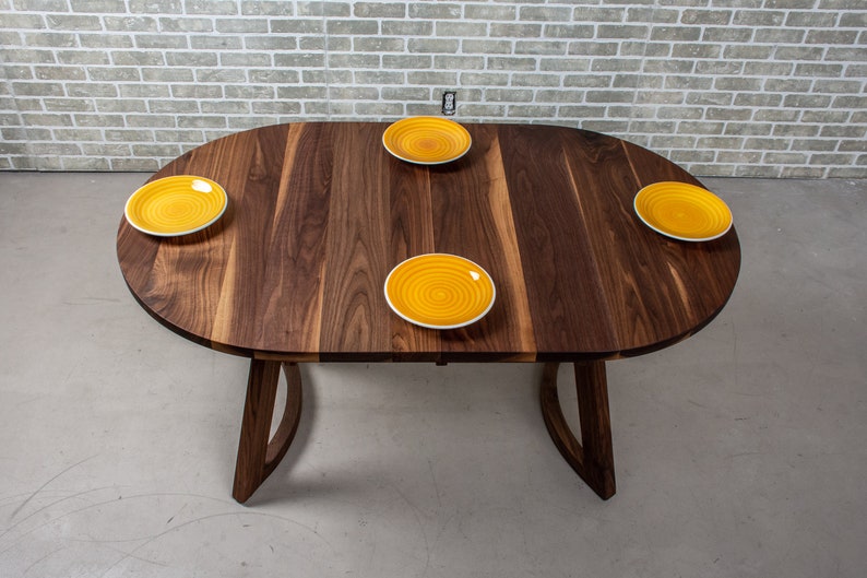 solid walnut oval table with leaves on wood curved legs