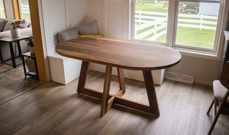 walnut racetrack oval table on single cross pedestal base