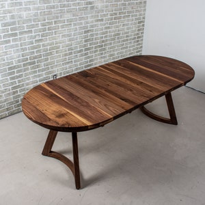 solid walnut oval table with leaves on wood curved legs