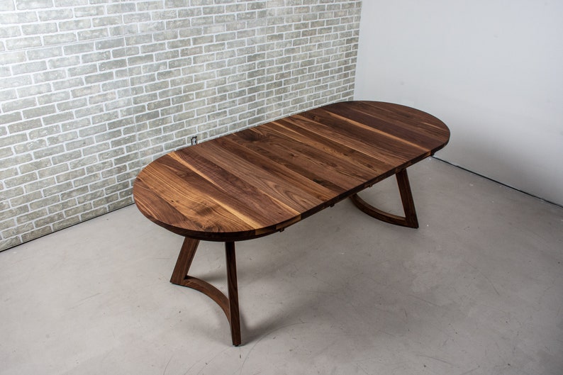 solid walnut oval table with leaves on wood curved legs