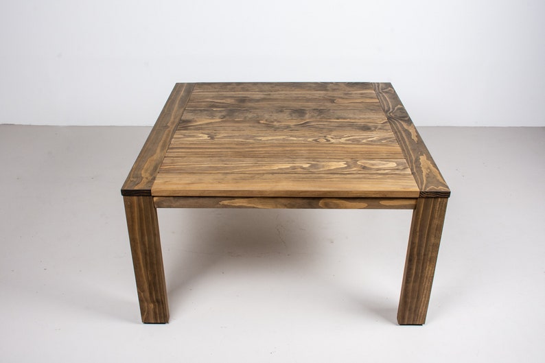 square outdoor dining table made with accoya wood on parson style base