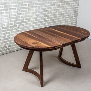 solid walnut oval table with leaves on wood curved legs