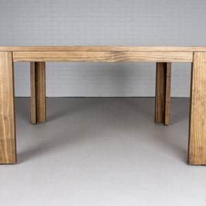 square outdoor dining table made with accoya wood on parson style base