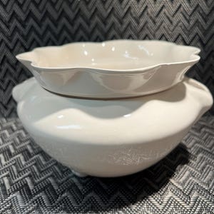May include: A trio of ceramic mugs with a speckled, matte finish in cream, light grey, and dark grey. Each mug features a simple, minimalist design, ideal for tea or coffee.