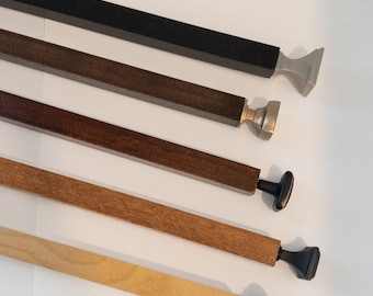 May include: Five different curtain rods with various finials. The rods are made of wood and metal and come in different colors and finishes. The finials are all different shapes and sizes.