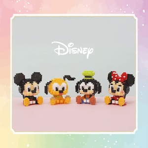 May include: Four small bead figures of Disney characters: Mickey Mouse, Minnie Mouse, Pluto, and Goofy. The figures are all in a sitting position and are made of colorful beads. The background is a light blue with the word "DISNEY" in white.