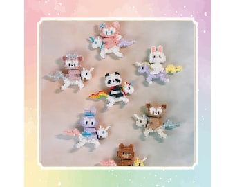 May include: A selection of colourful, pixelated animal figures riding unicorns. The figures include a panda, bear, bunny, and other animals. The unicorns have rainbow wings and manes. The figures are made of small, square blocks.