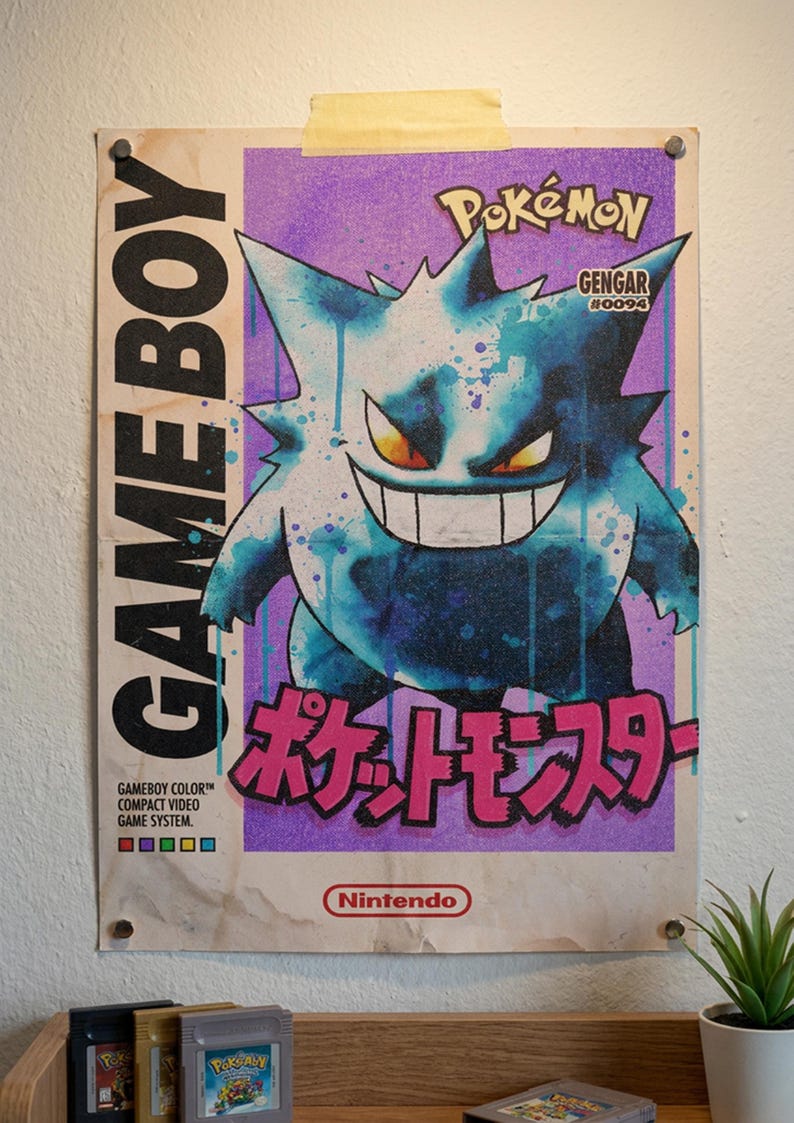 May include: A retro poster of the Pok&eacute;mon Gengar, with a purple and blue colour scheme. The poster includes the text "GAME BOY" and "Pok&eacute;mon" in bold fonts, along with the Japanese text "ポケットモンスター". The poster is mounted on a wall.