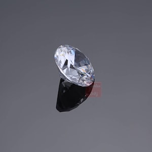 Pu&ograve; includere: Un grande diamante di forma ovale, trasparente, con molte sfaccettature.
